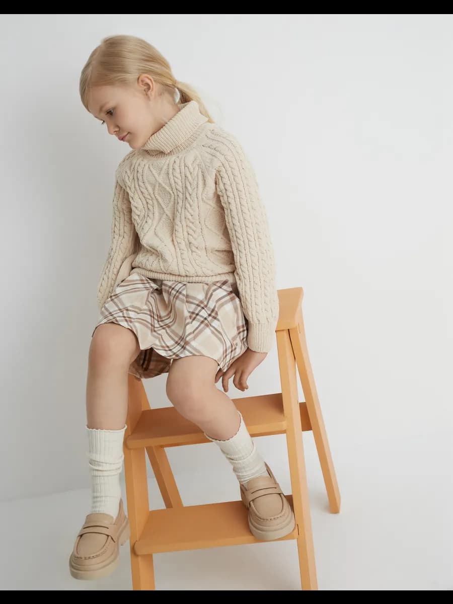 Бежевый свитер с косами